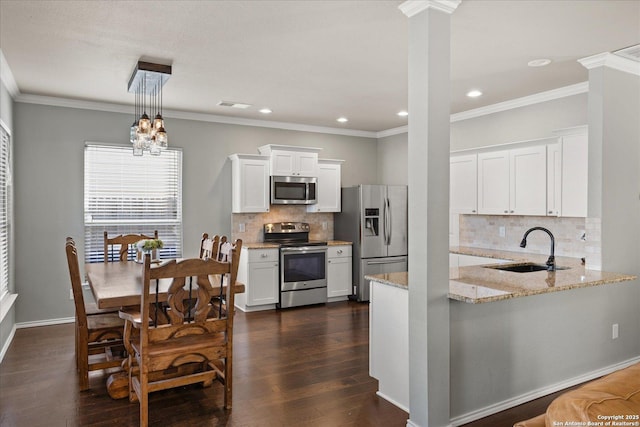 kitchen featuring backsplash, sink, white cabinets, and stainless steel appliances