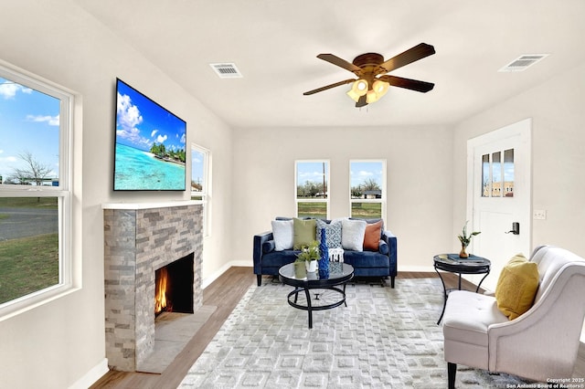 living room featuring ceiling fan and light hardwood / wood-style flooring