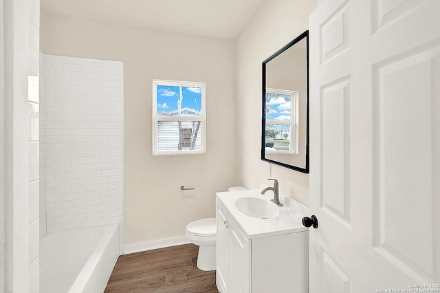 full bathroom with vanity, hardwood / wood-style flooring, toilet, and  shower combination