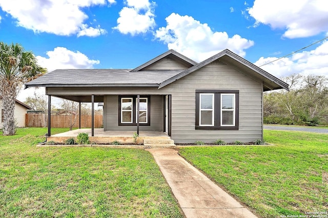 view of front of home with covered porch and a front yard