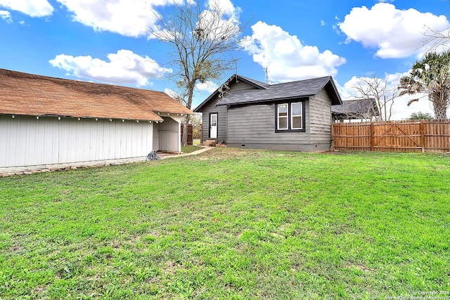 rear view of property featuring a yard