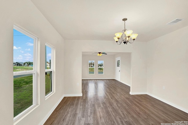 spare room with dark hardwood / wood-style floors and ceiling fan with notable chandelier