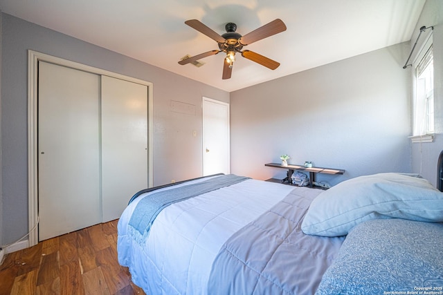 bedroom with a closet, ceiling fan, and dark wood-type flooring