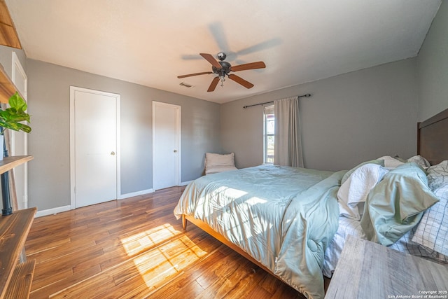 bedroom with hardwood / wood-style flooring and ceiling fan