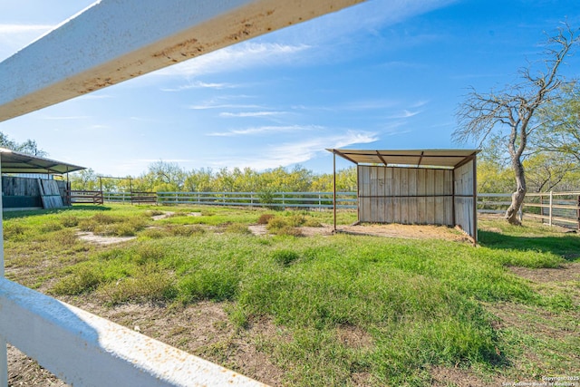 view of yard featuring an outbuilding and a rural view