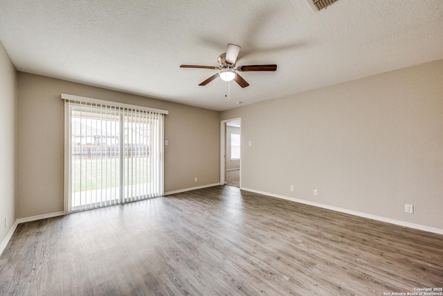 spare room with ceiling fan, wood-type flooring, and a textured ceiling