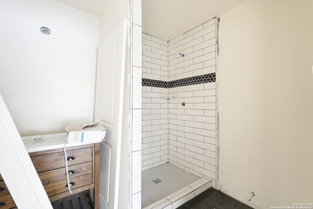 bathroom with tile patterned floors and a tile shower