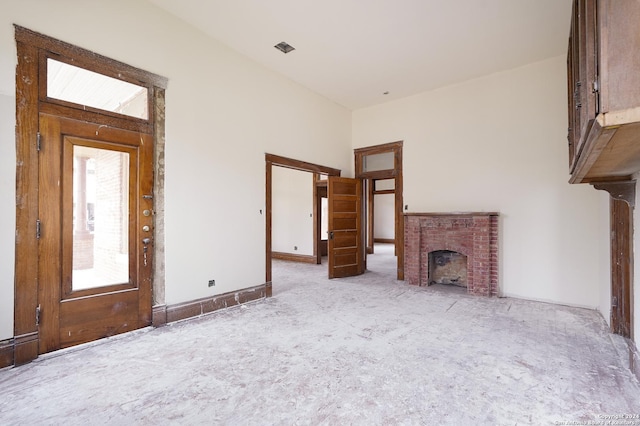 unfurnished living room featuring a brick fireplace