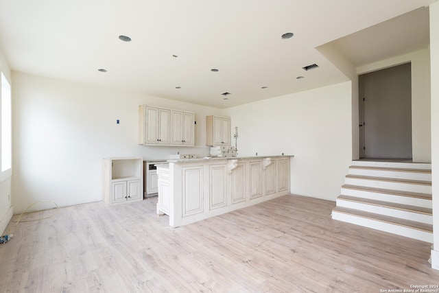 kitchen featuring cream cabinetry and light hardwood / wood-style floors