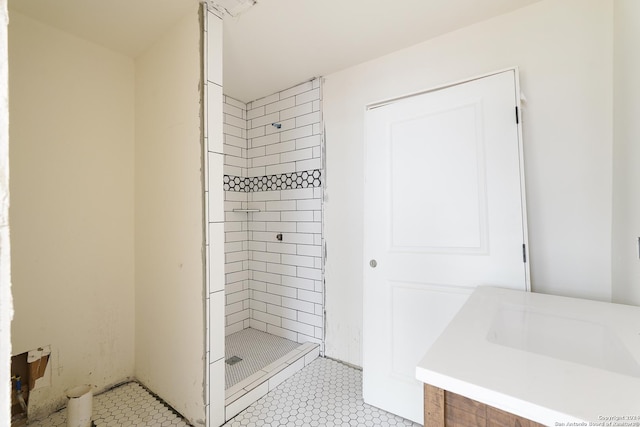 bathroom featuring a tile shower and vanity