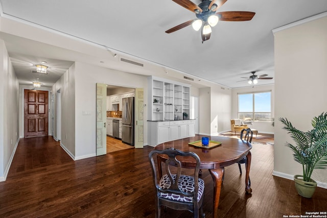 dining space with built in shelves, ceiling fan, and hardwood / wood-style floors