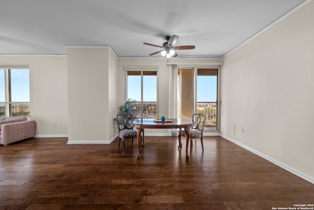 dining room with dark hardwood / wood-style flooring, crown molding, and plenty of natural light