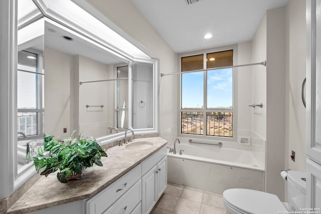 bathroom with a tub, tile patterned flooring, vanity, and toilet