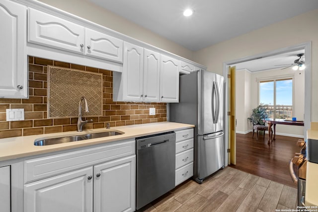 kitchen with ceiling fan, sink, white cabinets, and stainless steel appliances