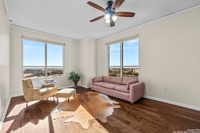 living room with dark hardwood / wood-style flooring, plenty of natural light, and crown molding