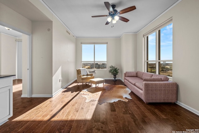 living room featuring ceiling fan, dark hardwood / wood-style flooring, and ornamental molding