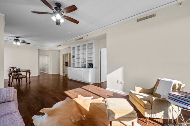 living room featuring built in features and dark wood-type flooring