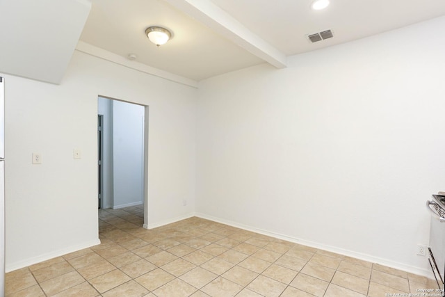 tiled spare room with beam ceiling