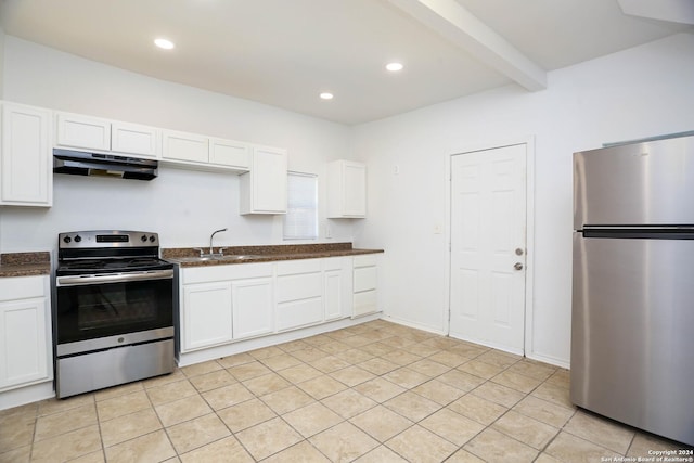 kitchen with beamed ceiling, light tile patterned flooring, white cabinets, and appliances with stainless steel finishes