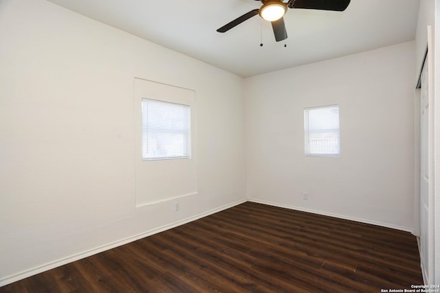 spare room with ceiling fan and dark wood-type flooring