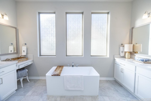 bathroom featuring a bathing tub, plenty of natural light, and vanity