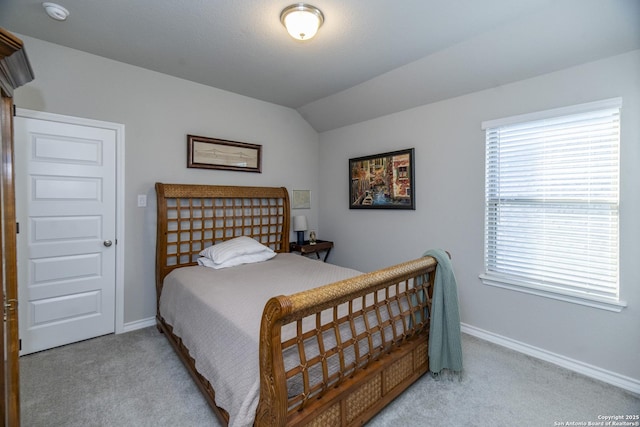 carpeted bedroom with vaulted ceiling