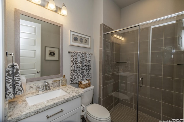 bathroom with vanity, toilet, and walk in shower