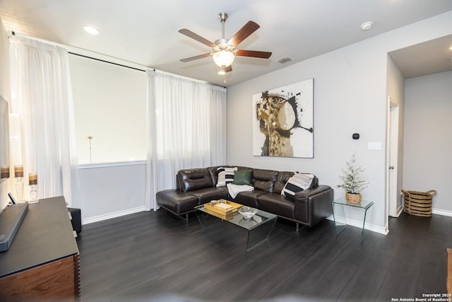 living room with ceiling fan and dark hardwood / wood-style floors