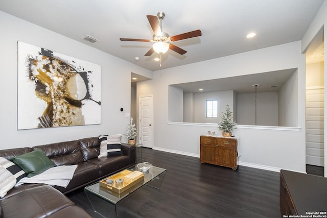 living room with ceiling fan and dark wood-type flooring