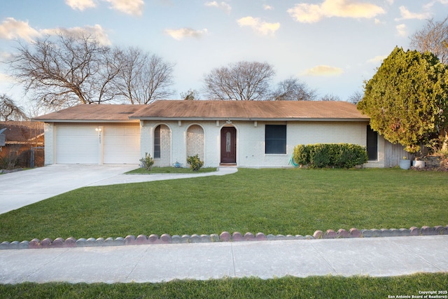 ranch-style house featuring a front lawn and a garage