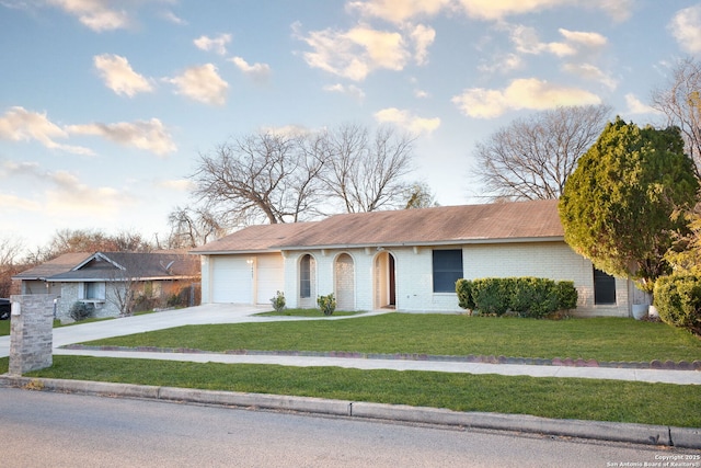 ranch-style home featuring a front yard and a garage