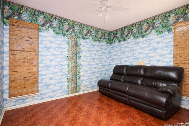 living room featuring ceiling fan, parquet floors, and a textured ceiling