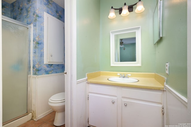 bathroom featuring walk in shower, tile patterned flooring, vanity, and toilet