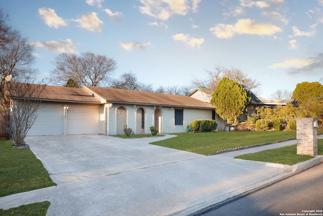 single story home featuring a front yard and a garage