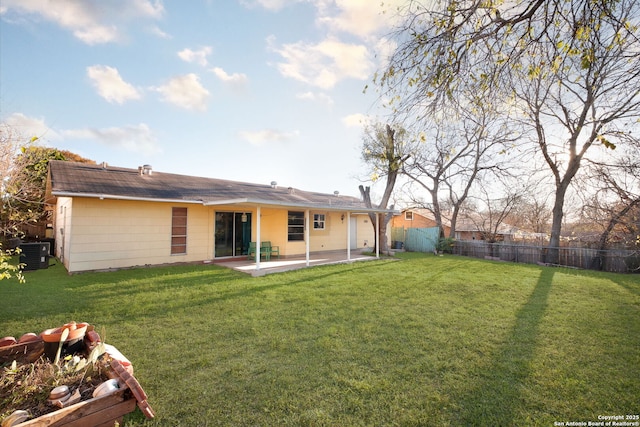 back of property featuring a yard, a patio, and central air condition unit