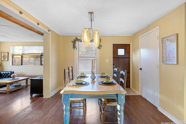 dining area featuring a chandelier and dark hardwood / wood-style floors