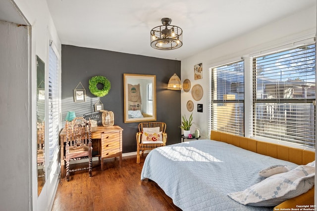 bedroom with dark hardwood / wood-style flooring