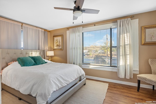 bedroom with hardwood / wood-style flooring and ceiling fan