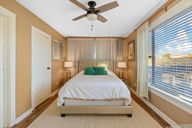 bedroom featuring wood-type flooring and ceiling fan