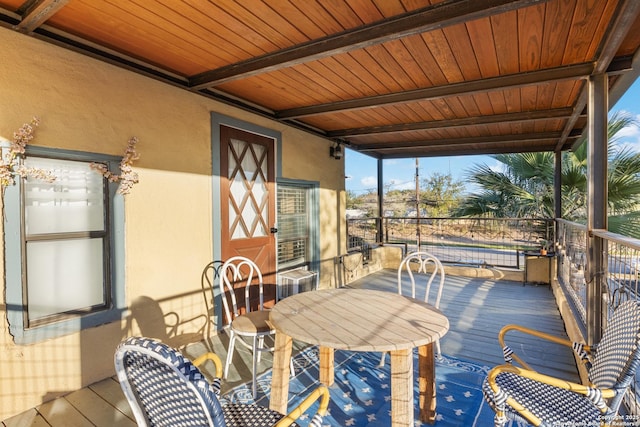 exterior space with beamed ceiling and wood ceiling