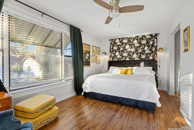 bedroom featuring ceiling fan and dark hardwood / wood-style flooring