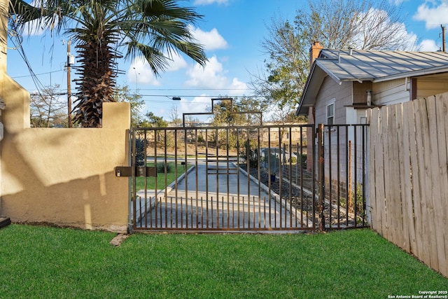 view of gate featuring a yard