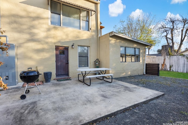 back of property with a patio