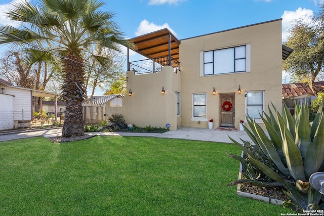 rear view of property with a lawn