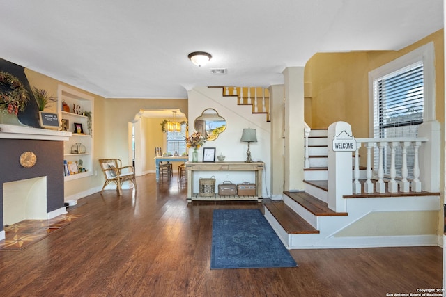 entryway with dark hardwood / wood-style floors and a healthy amount of sunlight