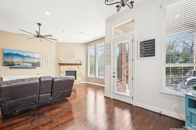 living room featuring a fireplace, dark hardwood / wood-style flooring, and ceiling fan