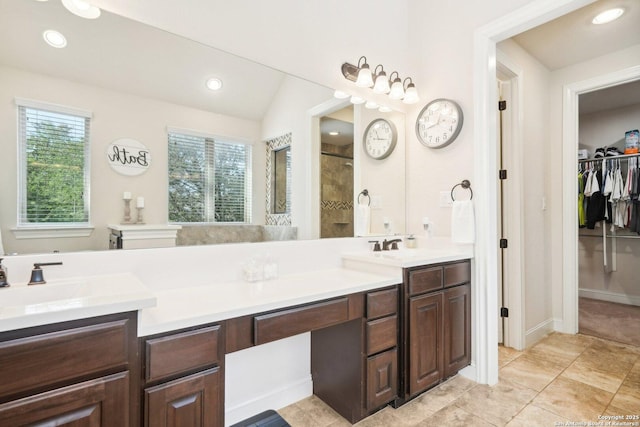 bathroom featuring a shower, vanity, and lofted ceiling