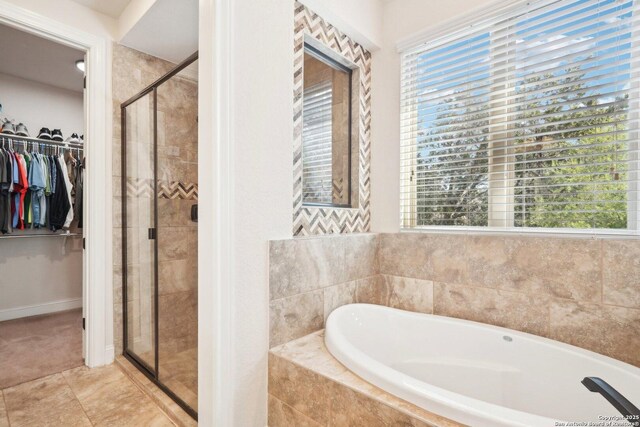 bathroom featuring separate shower and tub and tile patterned flooring