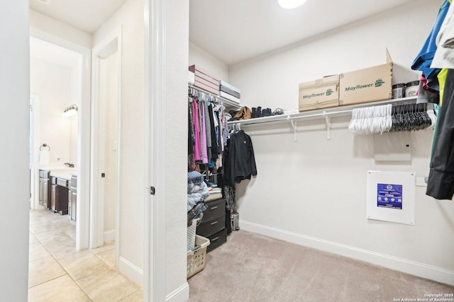 spacious closet featuring light tile patterned floors