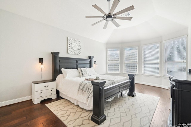 bedroom with lofted ceiling, multiple windows, ceiling fan, and dark hardwood / wood-style floors